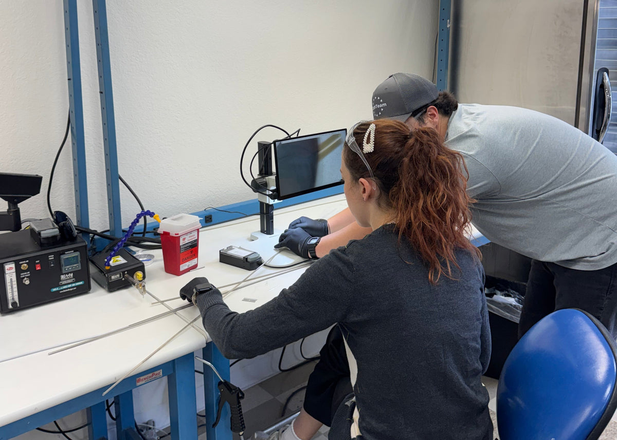 Engineers working at a training bench at CathTeam in Irvine, CA