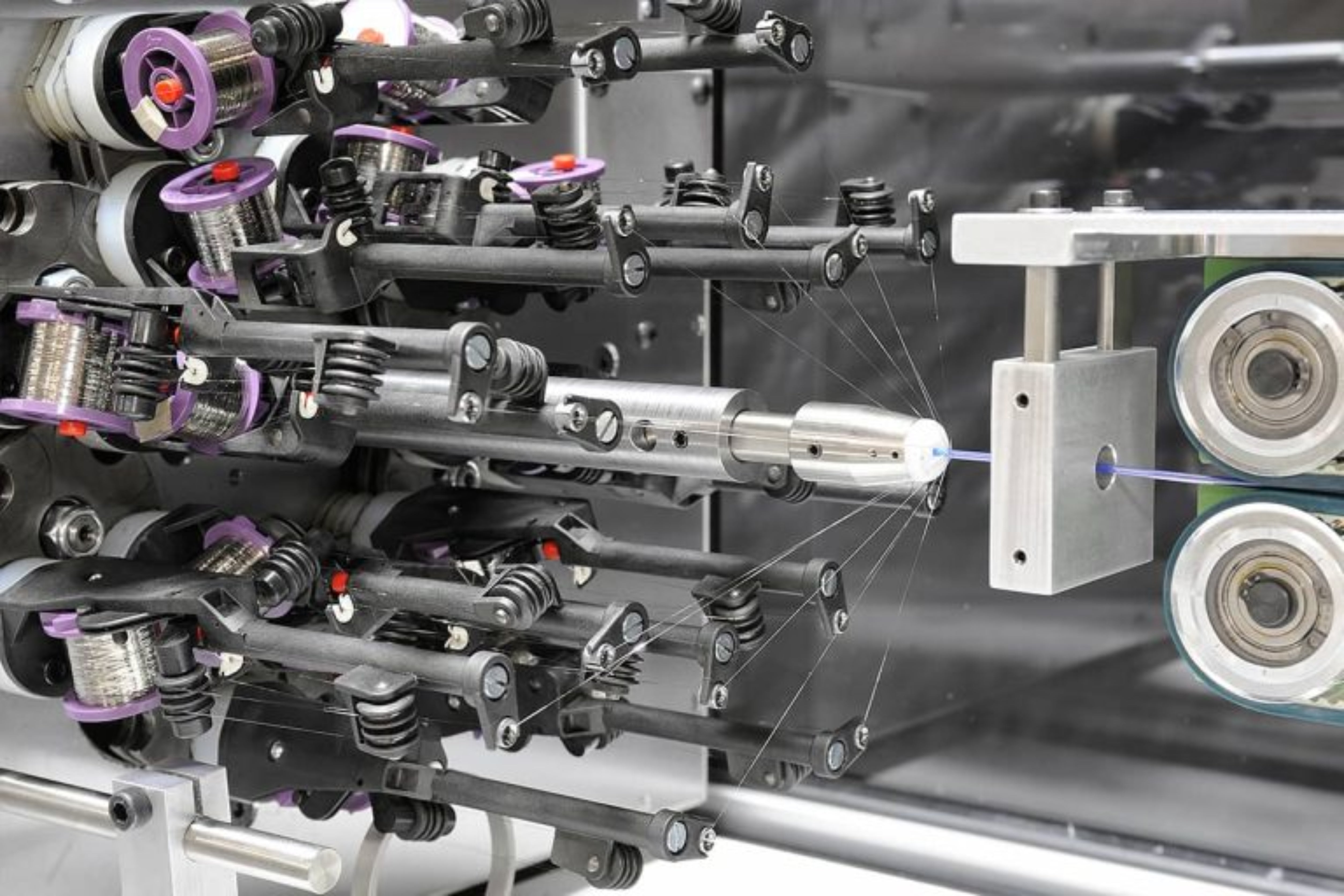 Close-up of a mechanical assembly with metal components and a laser.